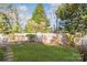 Lush backyard with a vibrant green lawn, stone pathway, and a classic white picket fence at 657 Heathridge Rd, Rock Hill, SC 29732