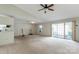 Spacious living room features neutral carpet, access to the kitchen, a ceiling fan and sliding glass doors at 657 Heathridge Rd, Rock Hill, SC 29732