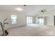 Expansive living room with neutral carpet, ceiling fan, leading to a sunroom and bedroom at 657 Heathridge Rd, Rock Hill, SC 29732