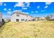 Expansive backyard of a two-story home with a sliding glass door and ample space for outdoor activities at 7314 Rupell Dr, Charlotte, NC 28273