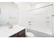 Well-lit bathroom featuring a bath tub and dark wood cabinets and white sink at 7314 Rupell Dr, Charlotte, NC 28273