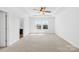 Large bedroom featuring neutral carpet, ceiling fan and natural light from the window at 7314 Rupell Dr, Charlotte, NC 28273