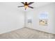 Well-lit bedroom featuring two bright windows and a ceiling fan at 7314 Rupell Dr, Charlotte, NC 28273