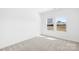 Bright bedroom with neutral carpet and natural light from two windows at 7314 Rupell Dr, Charlotte, NC 28273