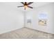 Bedroom with bright windows, ceiling fan, and plush carpeting at 7314 Rupell Dr, Charlotte, NC 28273