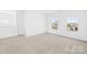 Spacious carpeted bedroom featuring two bright windows and neutral wall color at 7314 Rupell Dr, Charlotte, NC 28273