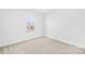 Bright bedroom with plush carpet, a window, and fresh neutral walls at 7314 Rupell Dr, Charlotte, NC 28273