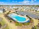 Aerial view of a community pool with inviting blue water, surrounded by lounge chairs and landscaped grounds at 7314 Rupell Dr, Charlotte, NC 28273