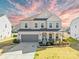 Charming two-story home featuring a two-car garage, landscaped yard, and covered front porch at 7314 Rupell Dr, Charlotte, NC 28273