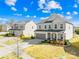 A view of a two-story home with a two-car garage, a well-kept lawn, and a friendly front porch at 7314 Rupell Dr, Charlotte, NC 28273