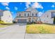 Inviting two-story home with a gray facade, attached garage, well-maintained lawn, and tasteful landscaping at 7314 Rupell Dr, Charlotte, NC 28273