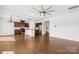 Open-concept living area featuring hardwood floors, an elegant chandelier, and a kitchen island at 7314 Rupell Dr, Charlotte, NC 28273