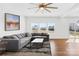 Spacious living room with a large sofa, wood floors, and plenty of natural light at 7314 Rupell Dr, Charlotte, NC 28273