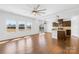 Spacious living area with hardwood floors, bright windows, and a seamlessly connected kitchen at 7314 Rupell Dr, Charlotte, NC 28273