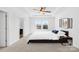 Cozy main bedroom with a tray ceiling, neutral carpet, and a side door access to bathroom at 7314 Rupell Dr, Charlotte, NC 28273