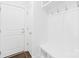 Clean mudroom with wooden flooring, built-in bench, and coat hooks at 7314 Rupell Dr, Charlotte, NC 28273