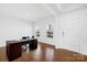 Bright office space with wood floors, a desk, and natural light from two windows at 7314 Rupell Dr, Charlotte, NC 28273