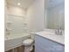 Well-lit bathroom featuring a bathtub/shower combo, a vanity with solid surface countertops, and modern fixtures at 828 Blue Canyon Dr, York, SC 29745