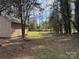 Green, lush backyard with a storage shed and mature trees at 8609 William Wiley Dr, Charlotte, NC 28215