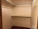 A small bedroom closet with shelving and a hanging rod for added storage at 8609 William Wiley Dr, Charlotte, NC 28215