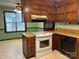 Kitchen with wooden cabinets, laminate countertops, white oven range, and black dishwasher at 8609 William Wiley Dr, Charlotte, NC 28215