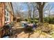 Brick patio with outdoor seating, grill, and inviting hammock, perfect for relaxing and entertaining at 1041 Cutler Pl, Charlotte, NC 28212
