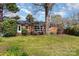 View of backyard featuring brick home with large window and lush green space at 1041 Cutler Pl, Charlotte, NC 28212