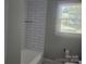 Modern bathroom featuring a tiled shower and updated fixtures and natural light from a large window at 1041 Cutler Pl, Charlotte, NC 28212