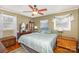 This bedroom features hardwood floors, ceiling fan, and updated windows at 1041 Cutler Pl, Charlotte, NC 28212