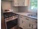 Updated kitchen features white cabinets, quartz countertops, and stainless steel appliances at 1041 Cutler Pl, Charlotte, NC 28212