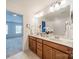 Bright bathroom featuring a double vanity, decorative mirror, and neutral finishes at 113 Burlingame Ct # C, Mooresville, NC 28117