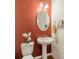 Cozy bathroom with pedestal sink, decorative mirror, and sconce lighting at 113 Burlingame Ct # C, Mooresville, NC 28117
