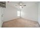Inviting bedroom with a ceiling fan, neutral carpet, and a window letting in natural light at 113 Burlingame Ct # C, Mooresville, NC 28117
