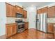 Kitchen featuring stainless steel appliances and wood cabinetry at 113 Burlingame Ct # C, Mooresville, NC 28117
