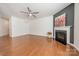 Spacious living room featuring a fireplace, ceiling fan, and beautiful hardwood floors at 113 Burlingame Ct # C, Mooresville, NC 28117