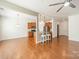Open concept kitchen with stainless steel appliances, hardwood floors, and breakfast bar seating at 113 Burlingame Ct # C, Mooresville, NC 28117