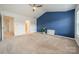 Bright main bedroom featuring a blue accent wall, vaulted ceilings, and neutral carpet at 113 Burlingame Ct # C, Mooresville, NC 28117
