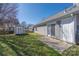 View of the backyard and side of the home, featuring a shed, gray siding and a patio at 114 Indian Paint Brush Dr, Mooresville, NC 28115