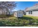 Backyard featuring a small shed and a partial view of the house at 114 Indian Paint Brush Dr, Mooresville, NC 28115