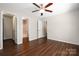 Spacious bedroom featuring a ceiling fan, wood-look floors and ensuite bathroom and closet at 114 Indian Paint Brush Dr, Mooresville, NC 28115