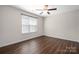 Bright bedroom featuring a ceiling fan, window and wood-look floors at 114 Indian Paint Brush Dr, Mooresville, NC 28115