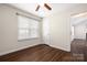 Bedroom featuring wood-look floors, a ceiling fan, and natural light from a window at 114 Indian Paint Brush Dr, Mooresville, NC 28115