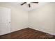 Bedroom features wood-look floors, a ceiling fan, and natural light from a window at 114 Indian Paint Brush Dr, Mooresville, NC 28115