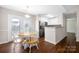 Dining area with hardwood floors, access to the backyard, and stainless steel appliances at 114 Indian Paint Brush Dr, Mooresville, NC 28115