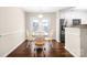 Cozy dining area featuring hardwood floors, a charming light fixture, and stainless steel appliances at 114 Indian Paint Brush Dr, Mooresville, NC 28115