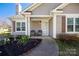 Inviting front porch with seating and a landscaped garden, creating a warm and welcoming entrance at 114 Indian Paint Brush Dr, Mooresville, NC 28115