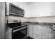 Galley kitchen featuring stainless steel oven and microwave with granite countertops at 114 Indian Paint Brush Dr, Mooresville, NC 28115