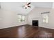 Bright living room with vaulted ceiling, fireplace, and large windows, offering ample natural light at 114 Indian Paint Brush Dr, Mooresville, NC 28115