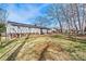 Expansive backyard with lush green grass, mature trees, a patio, and space for various outdoor activities at 1140 Knollwood Dr, Claremont, NC 28610