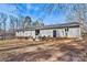 Spacious backyard with a patio, perfect for relaxing and enjoying outdoor living with mature trees surrounding at 1140 Knollwood Dr, Claremont, NC 28610